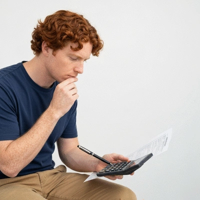 Person looking at dental insurance paperwork, weighing options