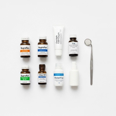 Assortment of dental emergency kit items on a clean white background